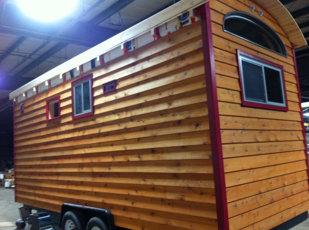 TURN ON IMAGES to see tiny house with red trim and cedar siding